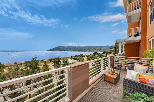 balcony with a water and mountain view