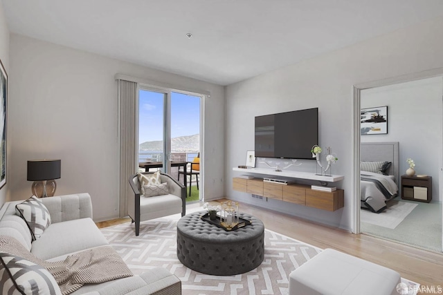 living room with visible vents and light wood-style flooring