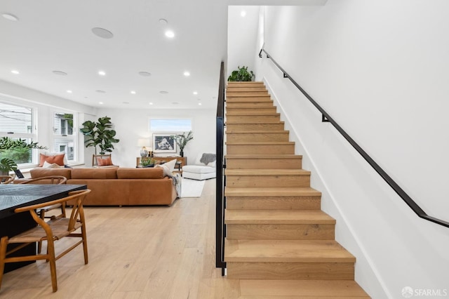 staircase with recessed lighting and wood finished floors