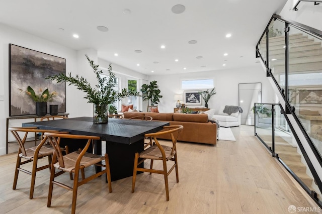 dining room with stairs, light wood-style flooring, and recessed lighting