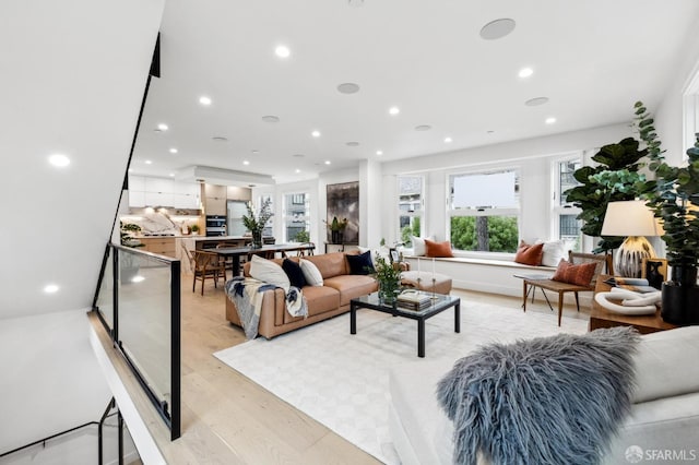 living area featuring recessed lighting and light wood finished floors