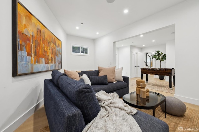 living room featuring recessed lighting, baseboards, and wood finished floors