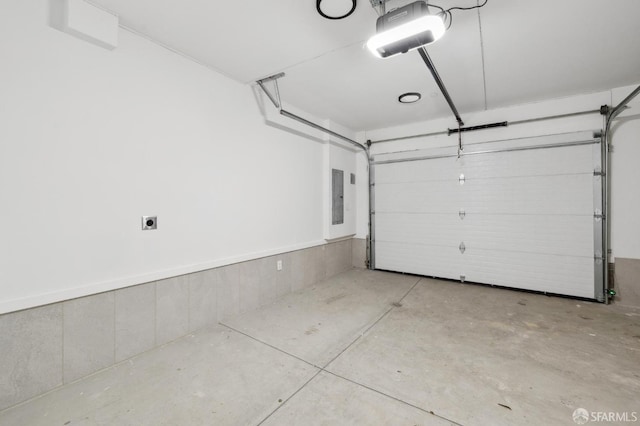 garage with electric panel and a garage door opener