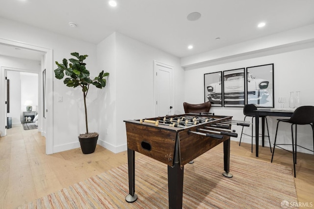 rec room with recessed lighting, light wood-type flooring, and baseboards