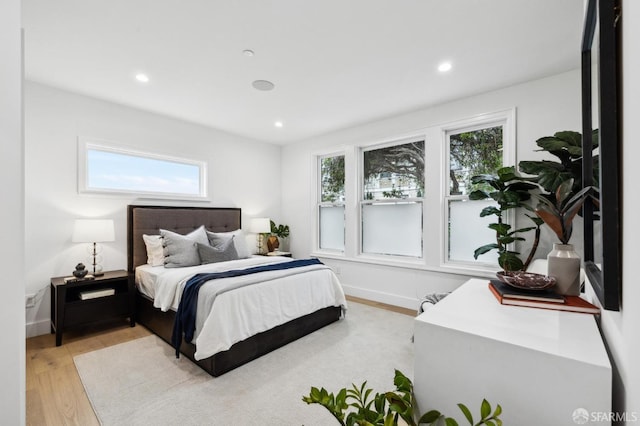 bedroom with recessed lighting, baseboards, and light wood-style flooring