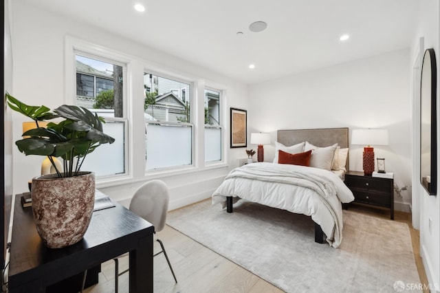 bedroom featuring recessed lighting, light wood-type flooring, and baseboards