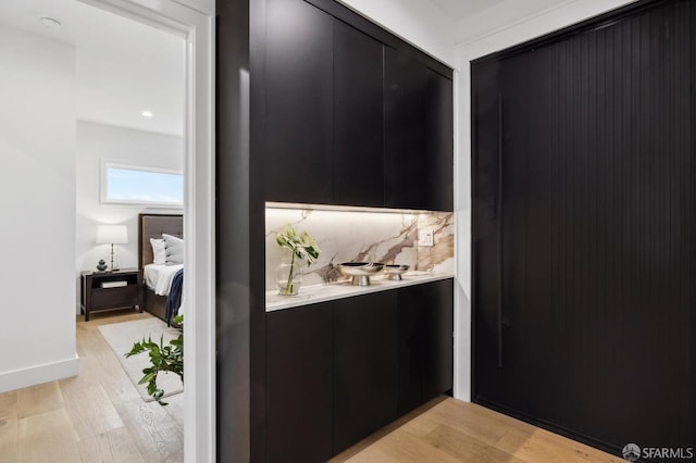 hallway with light wood finished floors and baseboards