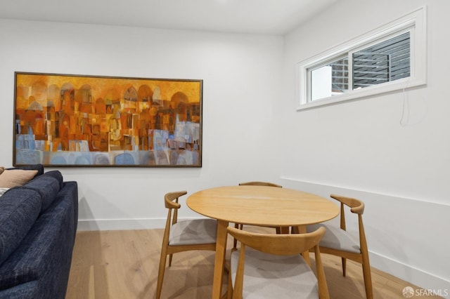 dining area featuring wood finished floors and baseboards