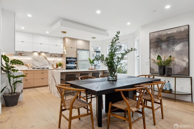 dining room with recessed lighting and light wood-style flooring