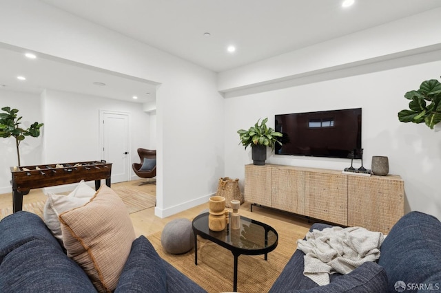 living area with light wood finished floors, recessed lighting, and baseboards