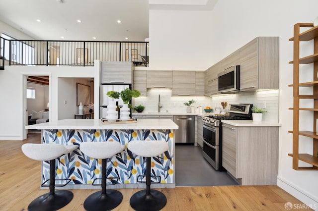 2011 3rd St Unit 6, San Francisco, CA 94107 - kitchen featuring appliances with stainless steel finishes, modern cabinets, a kitchen island, light countertops, and recessed lighting