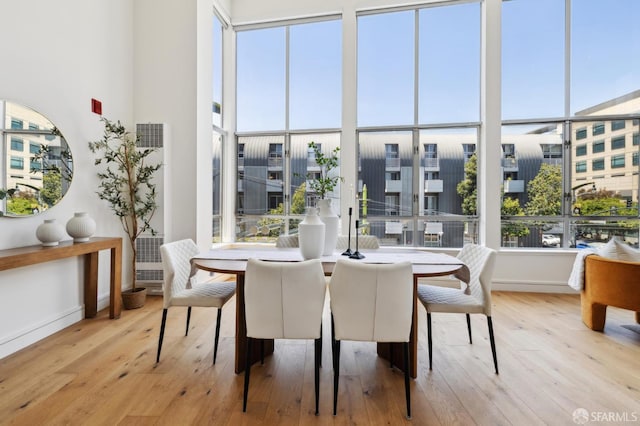 2011 3rd St Unit 6, San Francisco, CA 94107 - dining area with wood-type flooring, plenty of natural light, baseboards, and a towering ceiling