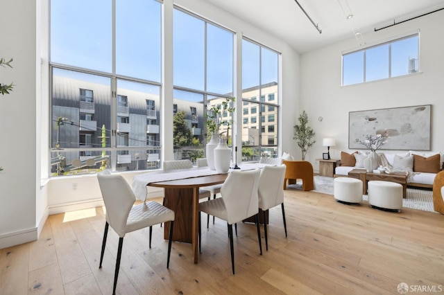 2011 3rd St Unit 6, San Francisco, CA 94107 - dining area featuring hardwood / wood-style flooring and a towering ceiling