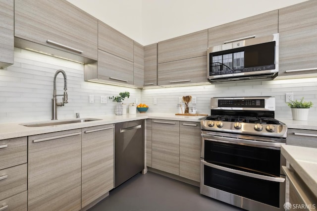 2011 3rd St Unit 6, San Francisco, CA 94107 - kitchen with appliances with stainless steel finishes, a sink, backsplash, modern cabinets, and light countertops