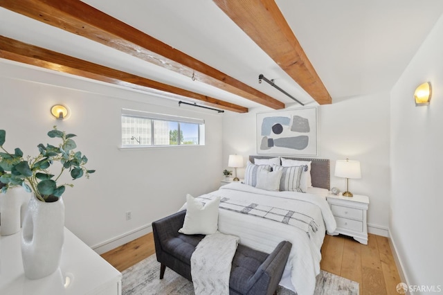 2011 3rd St Unit 6, San Francisco, CA 94107 - bedroom with baseboards, light wood-style floors, and beam ceiling
