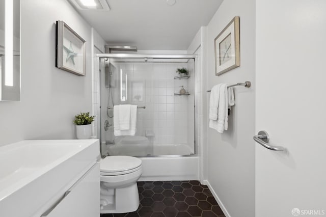 2011 3rd St Unit 6, San Francisco, CA 94107 - full bathroom with toilet, vanity, tile patterned floors, bath / shower combo with glass door, and baseboards