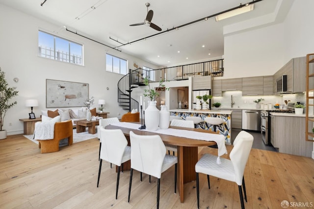 2011 3rd St Unit 6, San Francisco, CA 94107 - dining area with a high ceiling, stairway, light wood-style flooring, ceiling fan, and recessed lighting