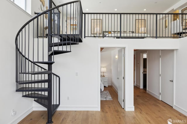 2011 3rd St Unit 6, San Francisco, CA 94107 - staircase with wood-type flooring, baseboards, a towering ceiling, and recessed lighting