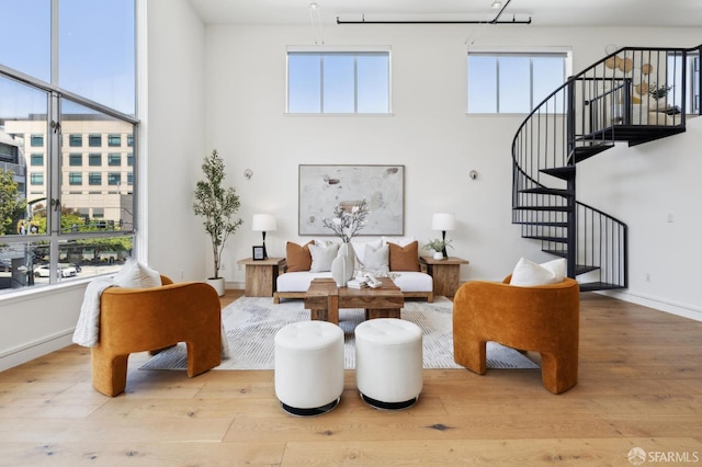 2011 3rd St Unit 6, San Francisco, CA 94107 - living area with wood finished floors, a towering ceiling, and stairs