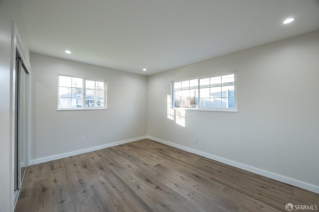 unfurnished bedroom featuring light hardwood / wood-style floors and a closet