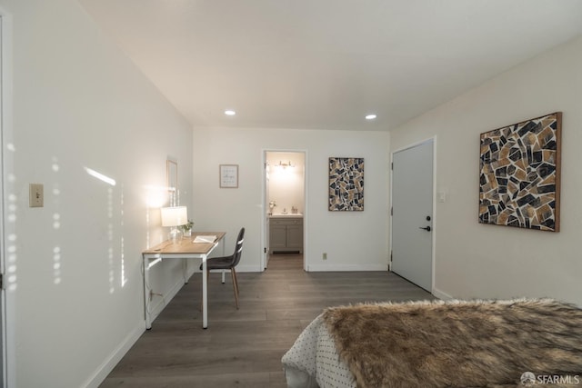 bedroom with connected bathroom and dark hardwood / wood-style floors