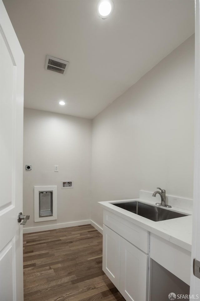 washroom with washer hookup, dark hardwood / wood-style flooring, electric dryer hookup, and sink