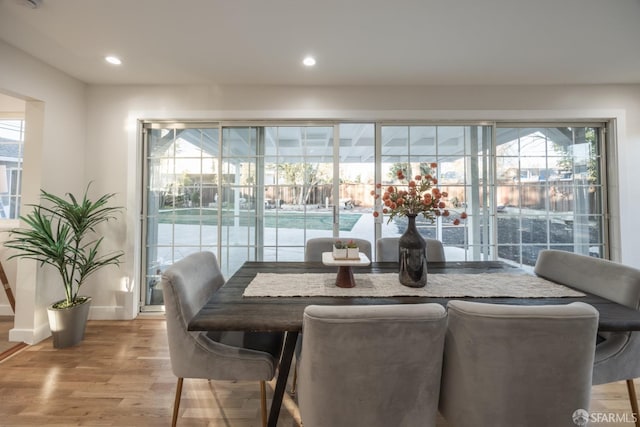 dining space featuring light wood-type flooring and a wealth of natural light