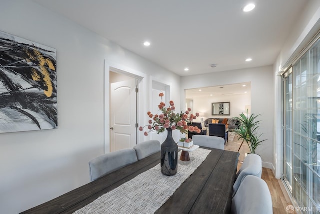 dining space with hardwood / wood-style floors