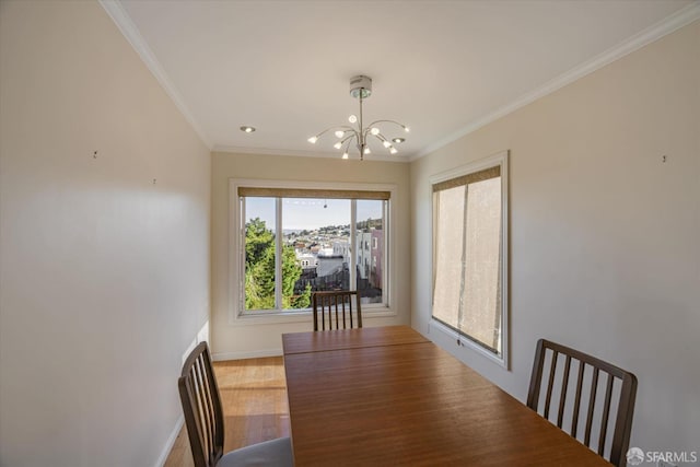 dining room featuring a notable chandelier, wood-type flooring, and crown molding