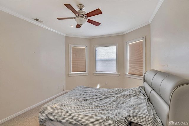 carpeted bedroom with ceiling fan and crown molding