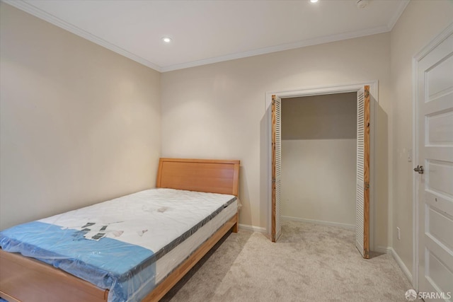 bedroom featuring crown molding, a closet, and light colored carpet