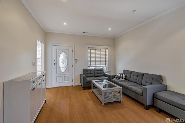 living room with light hardwood / wood-style floors and crown molding