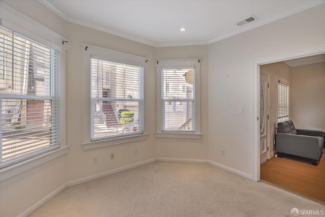 unfurnished room featuring light colored carpet and ornamental molding