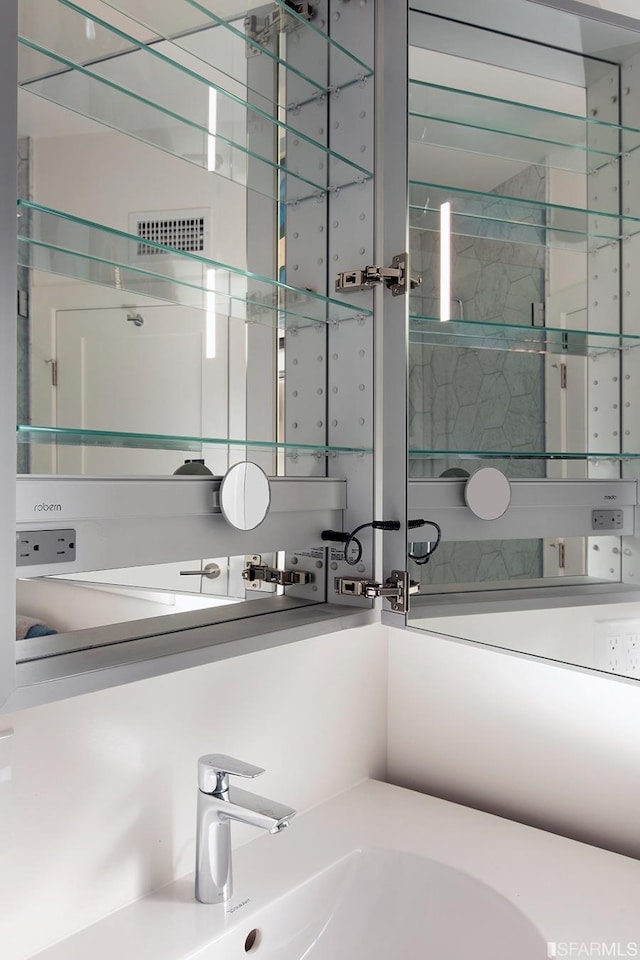 bathroom featuring visible vents and a sink