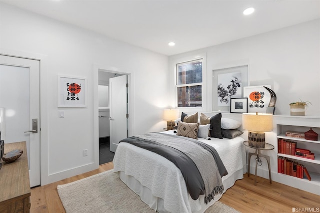 bedroom with recessed lighting and wood finished floors