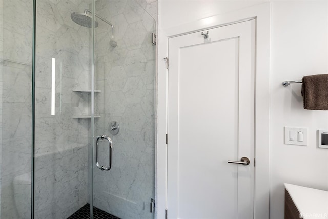 full bathroom with a marble finish shower