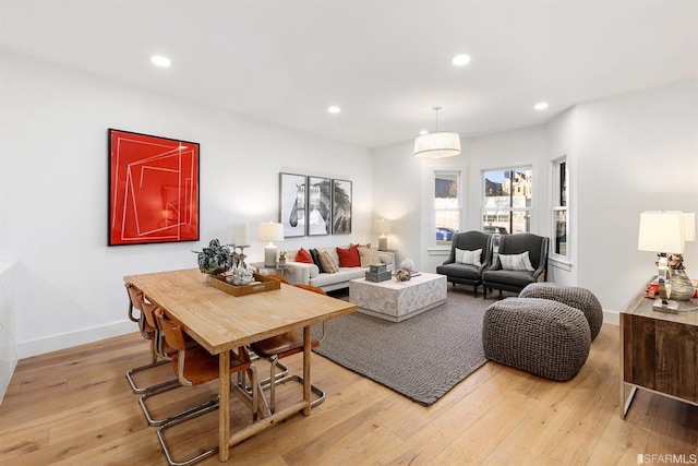 living area featuring light wood-type flooring, baseboards, and recessed lighting