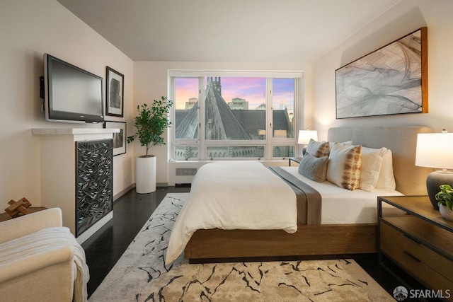 bedroom with dark wood-type flooring