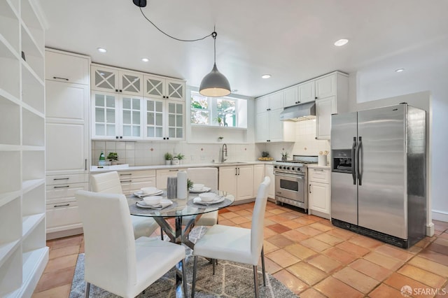 30 Eagle St, San Francisco, CA 94114 - kitchen featuring appliances with stainless steel finishes, under cabinet range hood, backsplash, white cabinetry, and recessed lighting