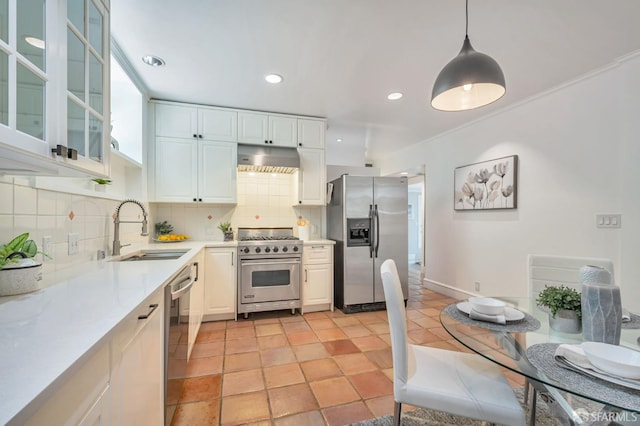 30 Eagle St, San Francisco, CA 94114 - kitchen featuring appliances with stainless steel finishes, decorative backsplash, light countertops, under cabinet range hood, and pendant lighting