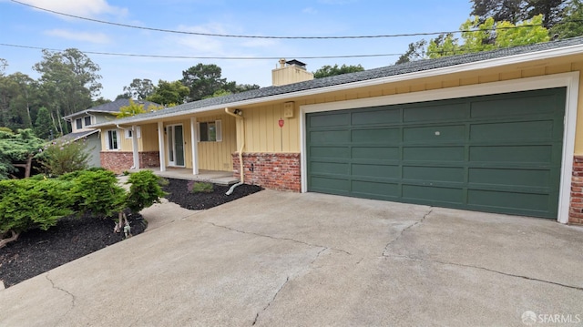 29 Woodcrest Cir, Oakland, CA 94602 - single story home with brick siding, a chimney, concrete driveway, covered porch, and a garage