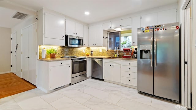 29 Woodcrest Cir, Oakland, CA 94602 - kitchen with appliances with stainless steel finishes, white cabinetry, light countertops, tasteful backsplash, and recessed lighting