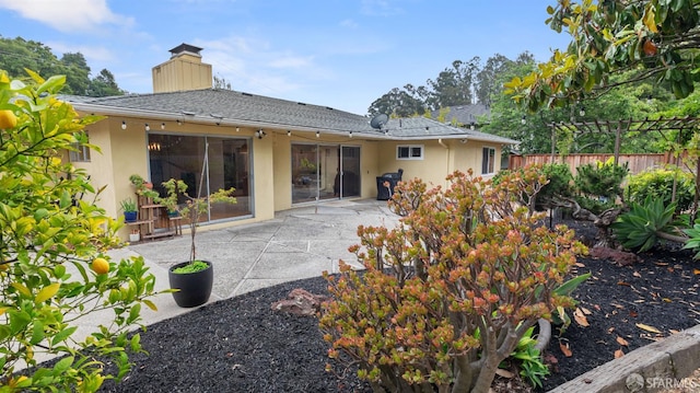 29 Woodcrest Cir, Oakland, CA 94602 - back of property with stucco siding, a chimney, and a patio