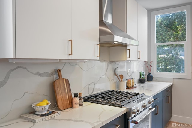 823 Hampshire St, San Francisco, CA 94110 - kitchen featuring stainless steel stove, extractor fan, tasteful backsplash, light stone countertops, and white cabinets