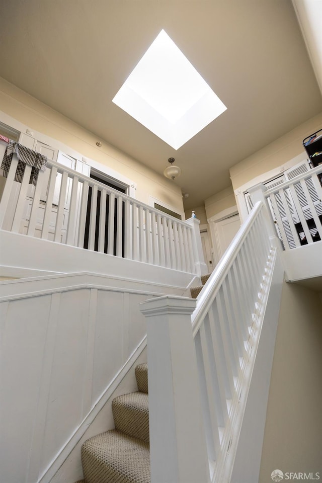 staircase featuring a skylight