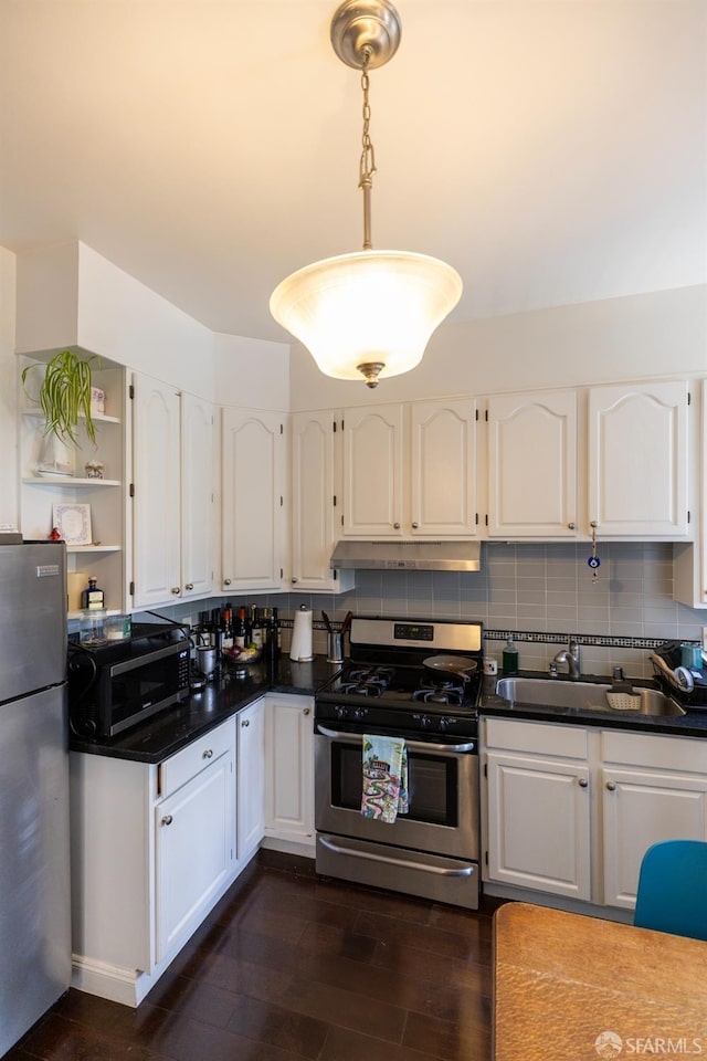 kitchen featuring appliances with stainless steel finishes, white cabinets, and a sink