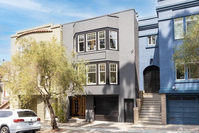 276 Funston Ave, San Francisco, CA 94118 - view of front of property featuring stucco siding, a garage, and driveway
