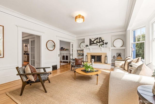 276 Funston Ave, San Francisco, CA 94118 - living room featuring ornamental molding, wood finished floors, a glass covered fireplace, and built in features