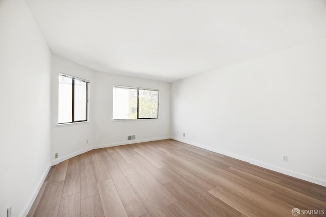 spare room featuring light hardwood / wood-style floors