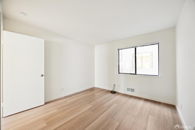 unfurnished room with light hardwood / wood-style floors